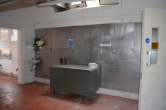 old kitchen, windows hidden by metal sheets.